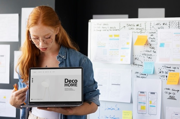 Female web designer in the office with laptop